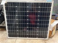 Front view of square framed NewPowa solar panel showing the monocrystalline cell layout in a grid.