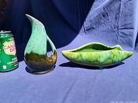 Photo showing Evangeline Pottery jug with green gradient glaze and Beauce Pottery green leaf-shaped planter alongside a soda can for scale.