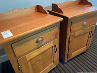Two wooden bedside tables side by side, showing overall design, drawer, cabinet door, and top with carved backplate.