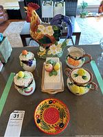 Full set arranged on table showing rooster jug, butter dish, salt and pepper shakers, sugar bowl, cream pitcher, and decorative plate.