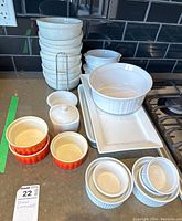 Overview photo showing majority of the ceramic cooking and serveware including bowls, ramekins, platters and small container.