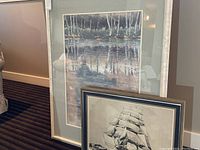 Both framed prints leaning against a wall, showing relative size and framing.