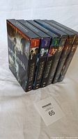 6 DVD box sets for seasons 1-6 of Supernatural TV series arranged side by side showing spines and front covers