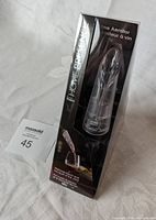 Front view of the wine aerator in its original packaging showing branding and product inside.