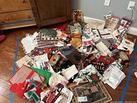 Wide view of assorted kitchen linens spread out on floor showing various holiday and seasonal designs