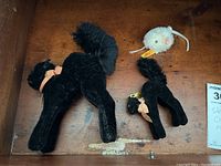 Overview of three plush figures: two black cats and one white mouse