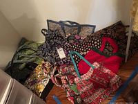 Group photo of multiple fabric bags including patterned Vera Bradley and Donna Sharp reversible bags