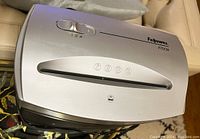 Top view of the Fellowes P70CM electric paper shredder showing the silver top with control switches and paper feed slot.