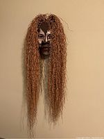 Front view of ceramic mask with long sweetgrass hair