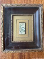 Framed floral miniature painting in detailed wooden frame with gold accents.