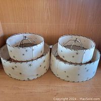 Two 1950s two-tier fiberglass lampshades with gold star pattern, showing overall appearance and dimensions.