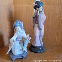 Both figurines side by side on shelf showing scale and overall appearance.