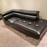 Side view of couch showing tufted leather seat cushions and padded backrests, L shaped design.