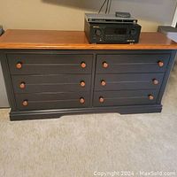 Main front view of the dresser showing six drawers with dark grey painted fronts and natural wood knobs and top.