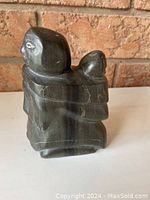 Front angle showing the mother and child detail with carved facial features and traditional Inuit garments.