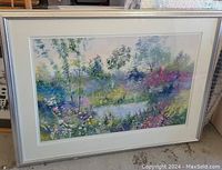 Frontal view of the signed oil landscape painting showing the scene of wildflowers around a pond, in original frame and matting.
