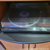 Yamaha TT-220 turntable on bottom shelf, clear dust cover closed