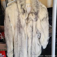 Front view of the vintage grey and white fur coat showing white leather seam detail and plush collar.