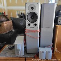 Overview showing two Wharfedale Diamond 9.4 speakers, Shockwave SC-3 unit, two satellite speakers and cables