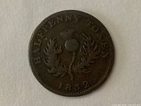 Reverse side photo showing thistle emblem, inscription "HALFPENNY TOKEN" and date "1832".