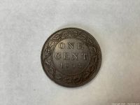 Reverse side showing ONE CENT and date 1903 with vine design border.