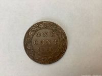 Reverse side of 1909 Canadian Large Penny showing denomination 'ONE CENT' and date surrounded by decorative leaf wreath pattern.