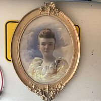 Full view of the oval framed watercolour portrait showing decorative gilt frame and painted subject.