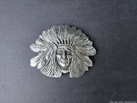 Front side showing detailed Native American chief with feathered headdress in relief.