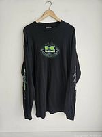Black Kawasaki sweatshirt on hanger showing full front and sleeves design.