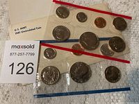 Photo showing complete 1981 U.S. Mint uncirculated coin set sealed in original plastic holders with red and blue borders.
