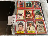 Plastic binder book open revealing a page of nine Superman II trading cards featuring characters such as Superman, Lois Lane, Perry White, and scenes from the movie.
