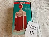 Photo of the original box featuring an image of the Coca-Cola salt and pepper shakers shaped as vintage gas pumps
