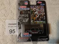 Photo showing unopened Fleer Team Collectible packaging containing a Tampa Bay Buccaneers diecast vehicle and a trading card from 1999, front view.