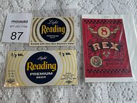 Photo showing three vintage beer labels, two Light Reading Premium Beer labels and one REX 8 Amsterdam Broom Co. label.