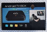 Front of the MX III Android TV Box packaging showing the product image and key features like quad core CPU, 4K UHD, H.265 HEVC, and KODI support.