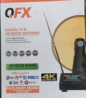 Box front of QFX Digital TV & HD Ready Indoor Antenna featuring 60 miles reception range, 4K Ultra HD, and local TV channel logos