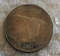 Obverse side of the coin showing a flying goose and the text "DOLLAR CANADA 1867/1967."
