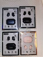 Four boxed sets of Fisher Rival Sound true wireless ear pods, showing front of packaging with earbuds and charging case visible.