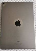 Back side of space gray iPad showing Apple logo and rear camera