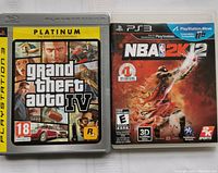 Photo showing two PlayStation 3 game cases: Grand Theft Auto IV Platinum edition and NBA 2K12, side by side.