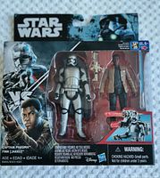 Front of the packaging showing the action figures Captain Phasma and Finn Jakkur, visible in packaging along with dual-projectile launcher accessories and Star Wars branding.