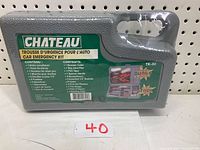 Photo of sealed grey plastic carrying case labeled Chateau car emergency kit TK-30 showing contents and model number