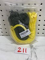 Two bundles of paracord, tightly coiled, yellow and green colors, packaged in clear plastic bag.
