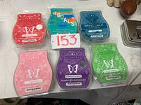 Six Scentsy wax scent bars arranged in two rows showing variety of colors and scents.