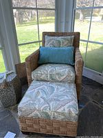 Front view of armchair with ottoman, showing overall composition and condition