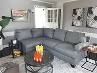 Three-quarter overview of L-shaped sectional showing corner, two-seat and one-seat modules in living room.