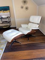 Front view of lounge chair and ottoman showing overall condition and design details