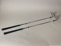 Two Callaway golf wedges side by side showing full clubs including grips and heads.