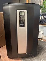 Front view of black Haier portable air conditioner showing control panel