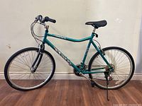 Side view of the teal Haro Vector bicycle showing the full bike frame, handlebar, seat, pedals, and tires.